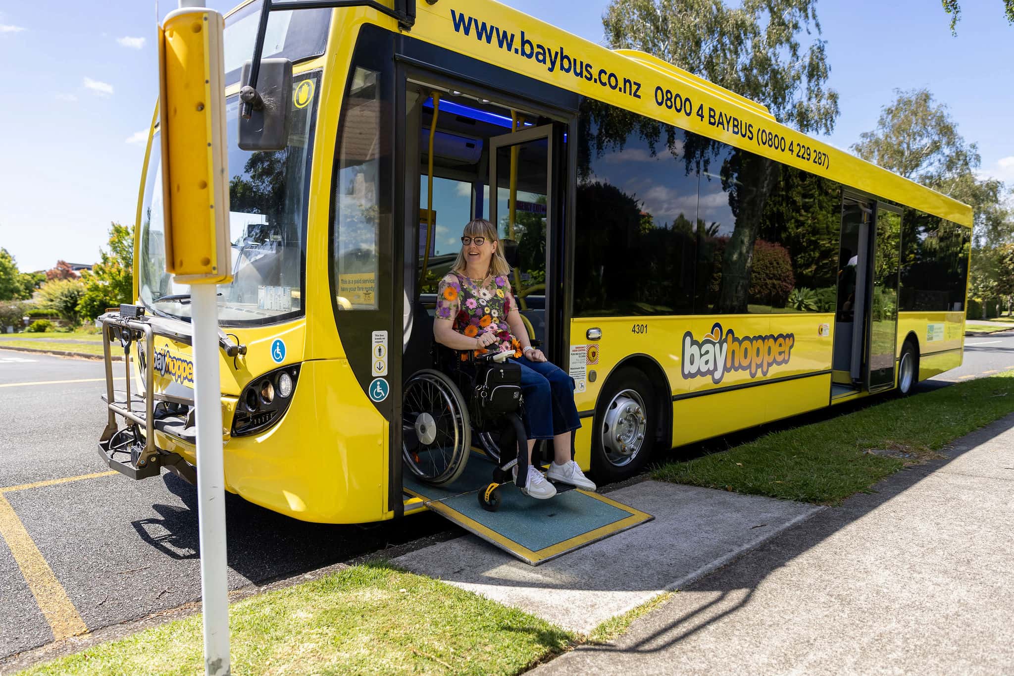 Bus with accessible ramp for woman in wheelchair