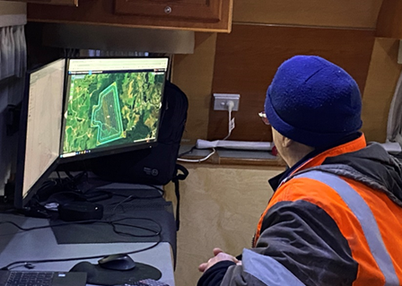 Man looking at computer map monitoring Endean Forest wallabies