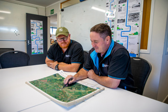 Two men looking at a mpa