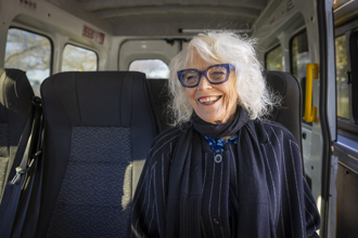 Older woman sitting on a bus